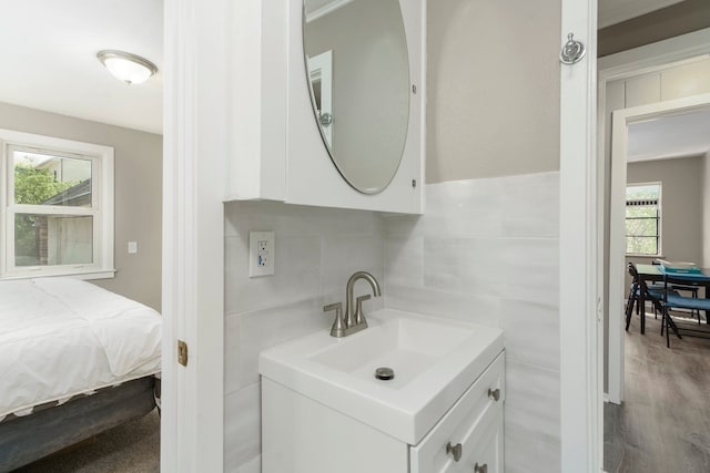 5721 Corunna Ave, Clarkston, MI 48346 - bathroom with tile walls, vanity, and wood finished floors