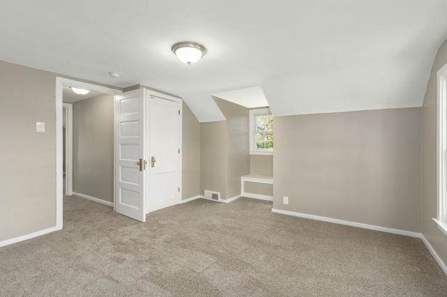 5721 Corunna Ave, Clarkston, MI 48346 - additional living space with carpet flooring, baseboards, and vaulted ceiling