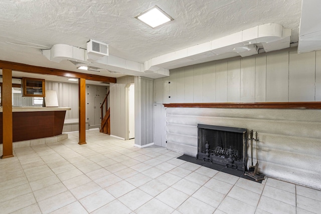 5721 Corunna Ave, Clarkston, MI 48346 - finished below grade area featuring stairway, a textured ceiling, tile patterned floors, and a fireplace