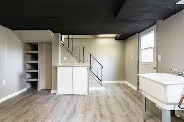 5721 Corunna Ave, Clarkston, MI 48346 - below grade area featuring light wood finished floors, stairs, and baseboards