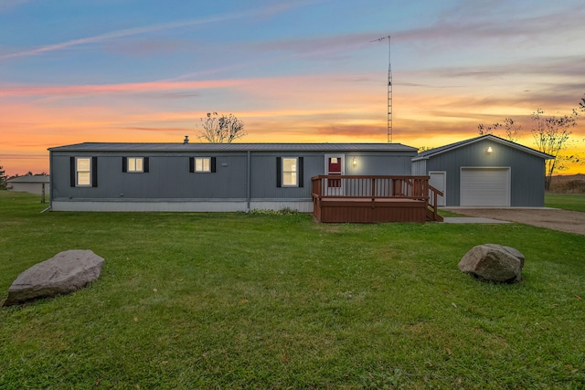 manufactured / mobile home with a yard and a deck