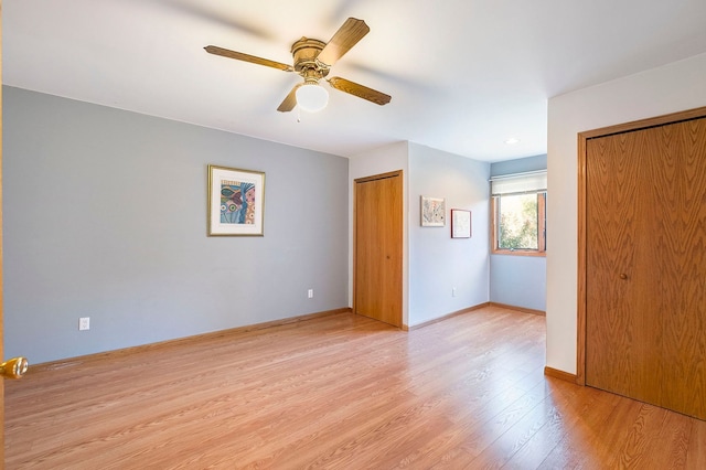 spare room with ceiling fan and light wood-type flooring