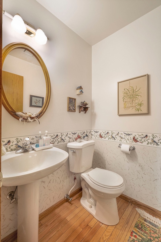 bathroom with wood-type flooring and toilet