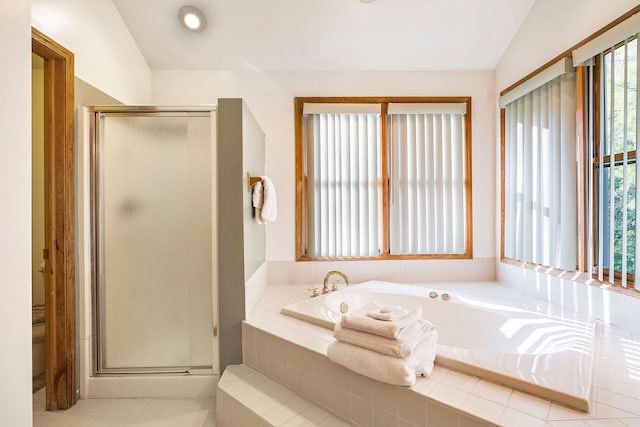 bathroom with separate shower and tub, vaulted ceiling, and plenty of natural light