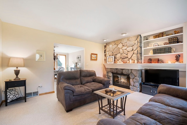 living room with light colored carpet and a stone fireplace