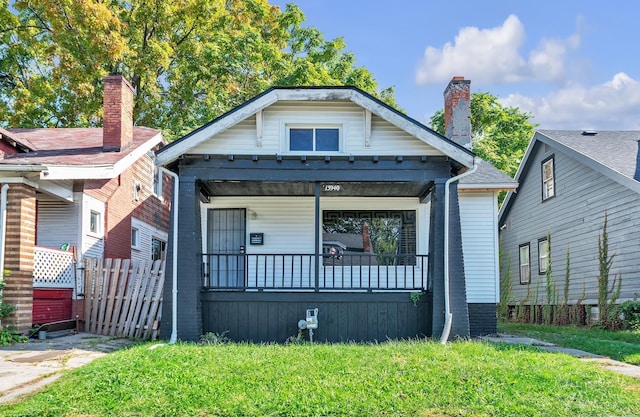 bungalow-style house featuring a front lawn and a porch