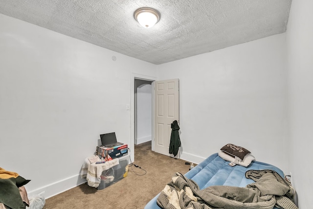 carpeted bedroom with a textured ceiling