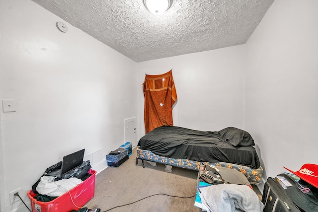 carpeted bedroom with a textured ceiling