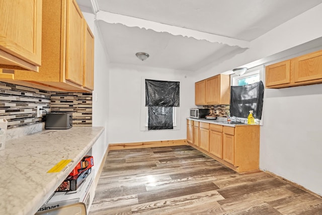 kitchen featuring backsplash, light brown cabinets, and dark hardwood / wood-style floors