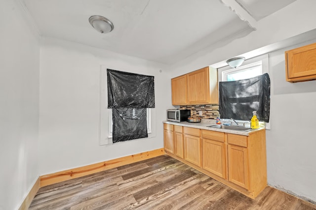 kitchen featuring light brown cabinets, sink, dark wood-type flooring, and tasteful backsplash