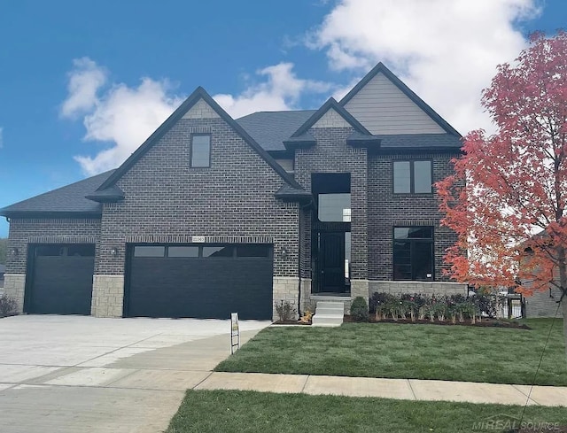 view of front of property with a garage and a front yard