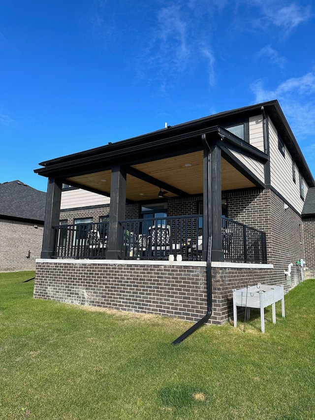 rear view of property featuring a yard