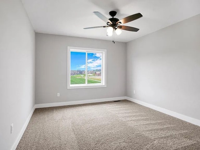 spare room featuring ceiling fan and carpet flooring