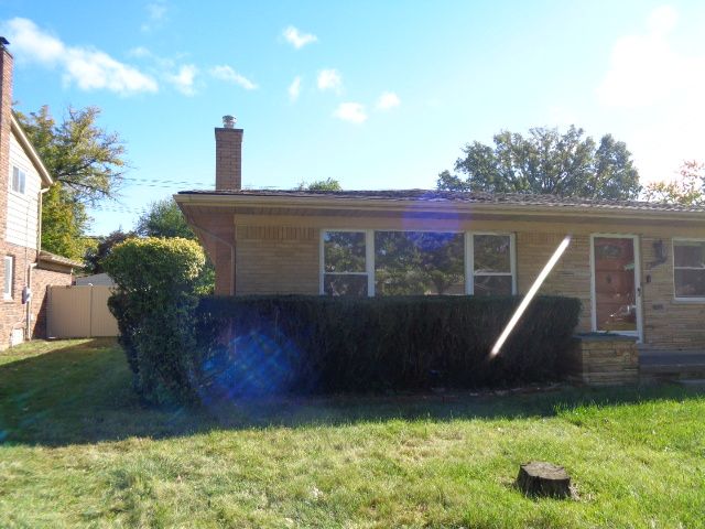 view of side of property with a lawn