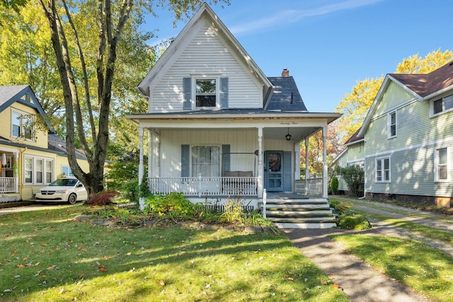 view of front of house featuring a front lawn and covered porch