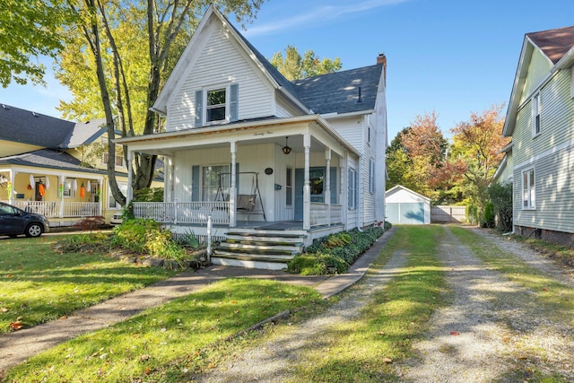 view of front of home with an outbuilding, a porch, and a garage