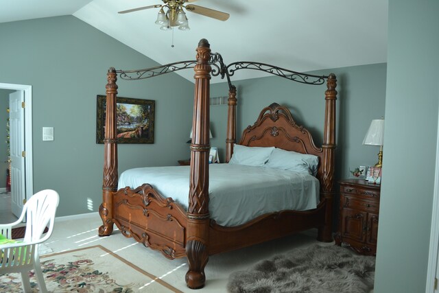 carpeted bedroom with ceiling fan and lofted ceiling