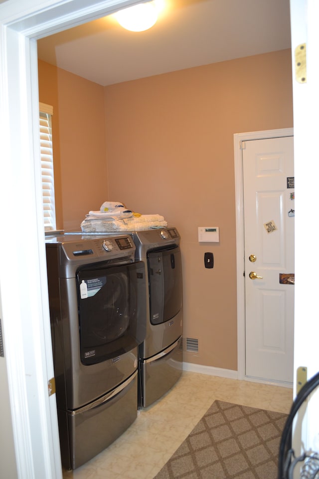 laundry area with separate washer and dryer