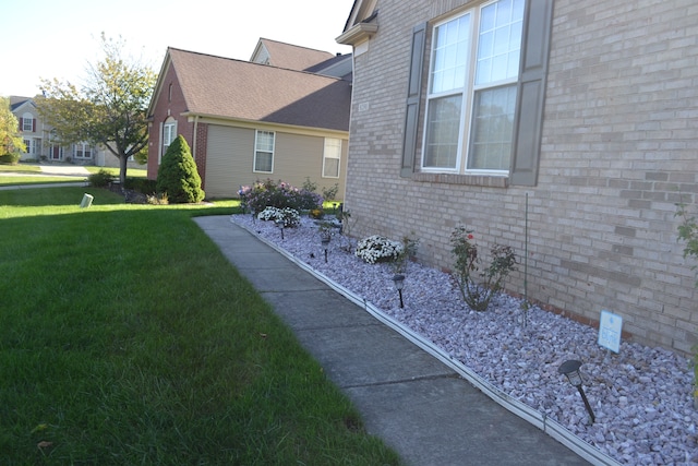 view of home's exterior with a yard