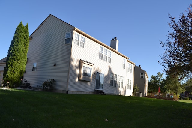 back of property featuring a lawn