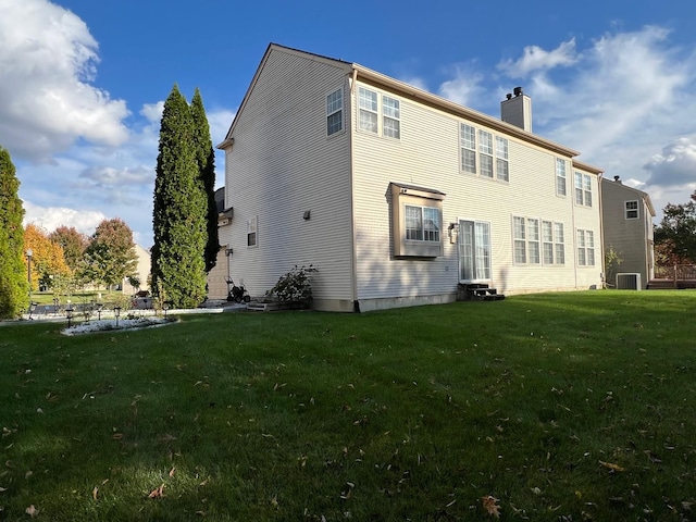 back of house with a yard and cooling unit