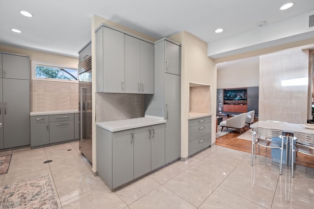 kitchen with gray cabinets and built in refrigerator