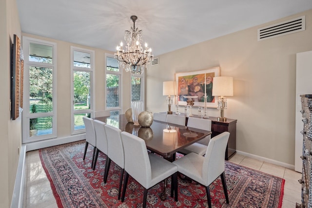 dining room with light tile patterned floors and an inviting chandelier