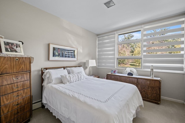 bedroom featuring baseboard heating and carpet flooring