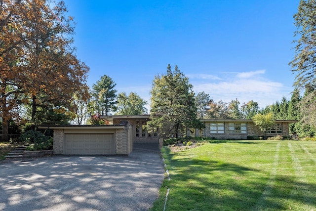 single story home with a front yard and a garage