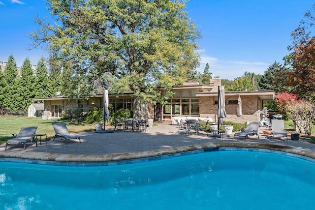 view of pool featuring a patio