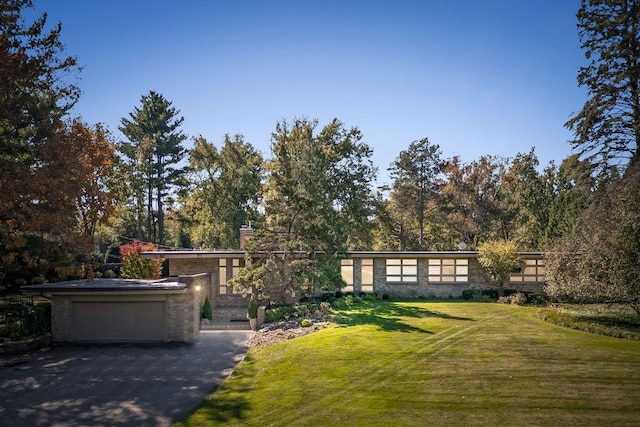 view of front facade with a front yard and a garage