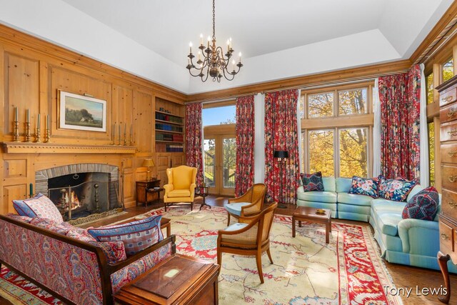 610 Cascade Hills Holw SE, Grand Rapids, MI 49546 - living area with plenty of natural light, a chandelier, built in features, and a brick fireplace