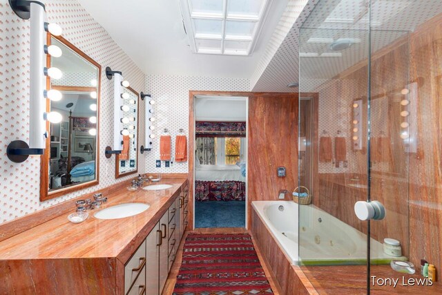 610 Cascade Hills Holw SE, Grand Rapids, MI 49546 - full bathroom with ensuite bathroom, a whirlpool tub, wallpapered walls, a shower, and double vanity