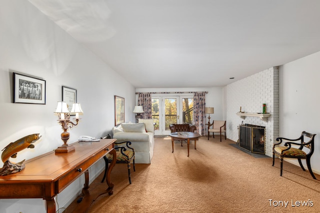 carpeted living room with a brick fireplace