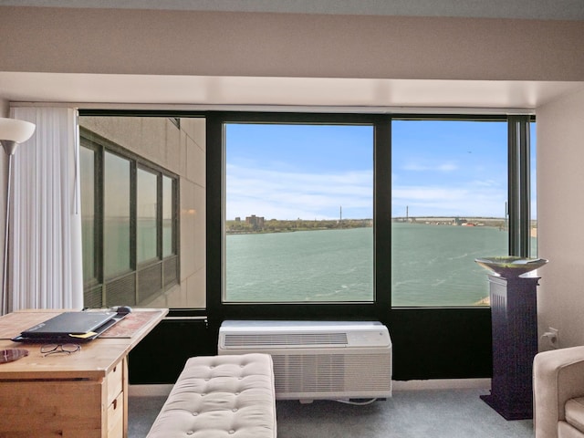 interior space with a wall mounted air conditioner and a water view