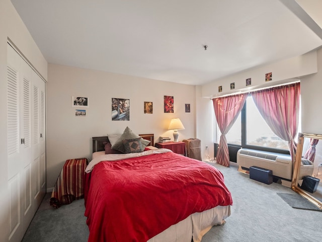 bedroom featuring carpet floors, an AC wall unit, and a closet