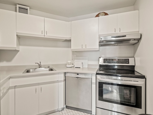 kitchen featuring stainless steel appliances, white cabinetry, and sink