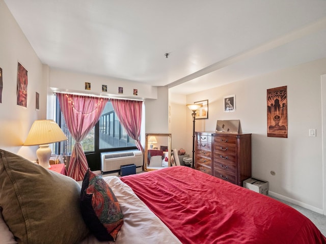 carpeted bedroom featuring an AC wall unit