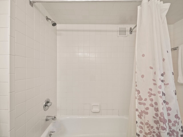 bathroom with shower / bath combo with shower curtain