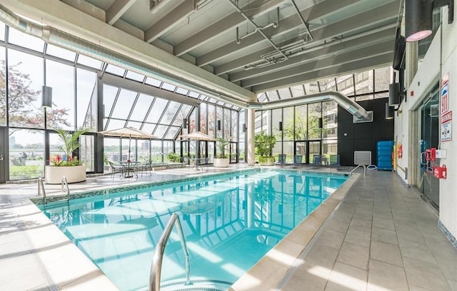 view of pool with a lanai and a patio