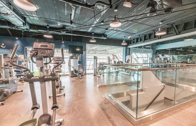 workout area with plenty of natural light and wood-type flooring