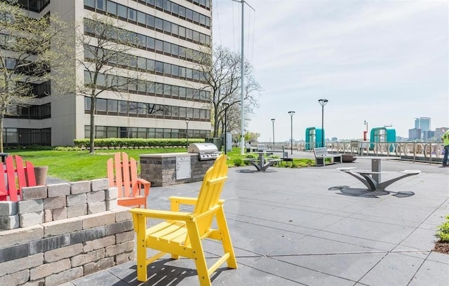 view of home's community with a yard and an outdoor kitchen