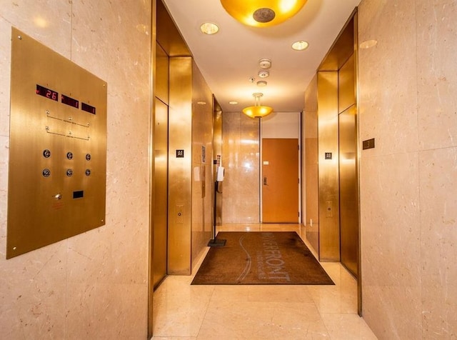 hall with light tile patterned floors