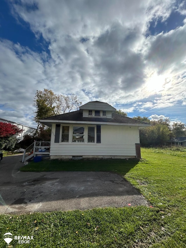 view of property exterior with a yard