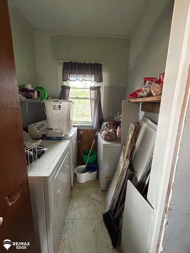 clothes washing area featuring separate washer and dryer