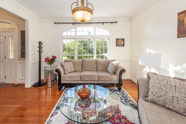 living room with wood-type flooring and crown molding