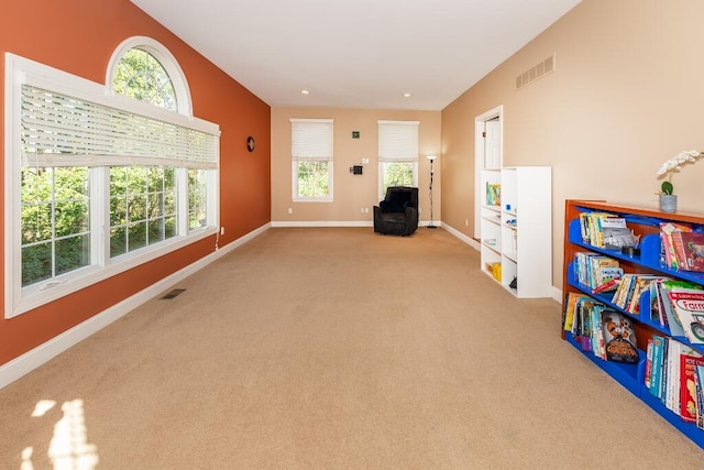 game room with light colored carpet