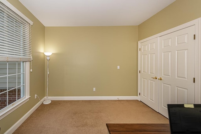 unfurnished bedroom with a closet and carpet