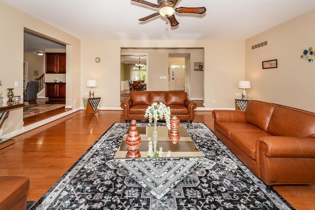 living room with hardwood / wood-style floors and ceiling fan