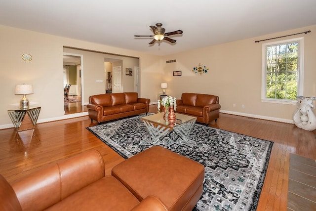 living room with ceiling fan and wood-type flooring